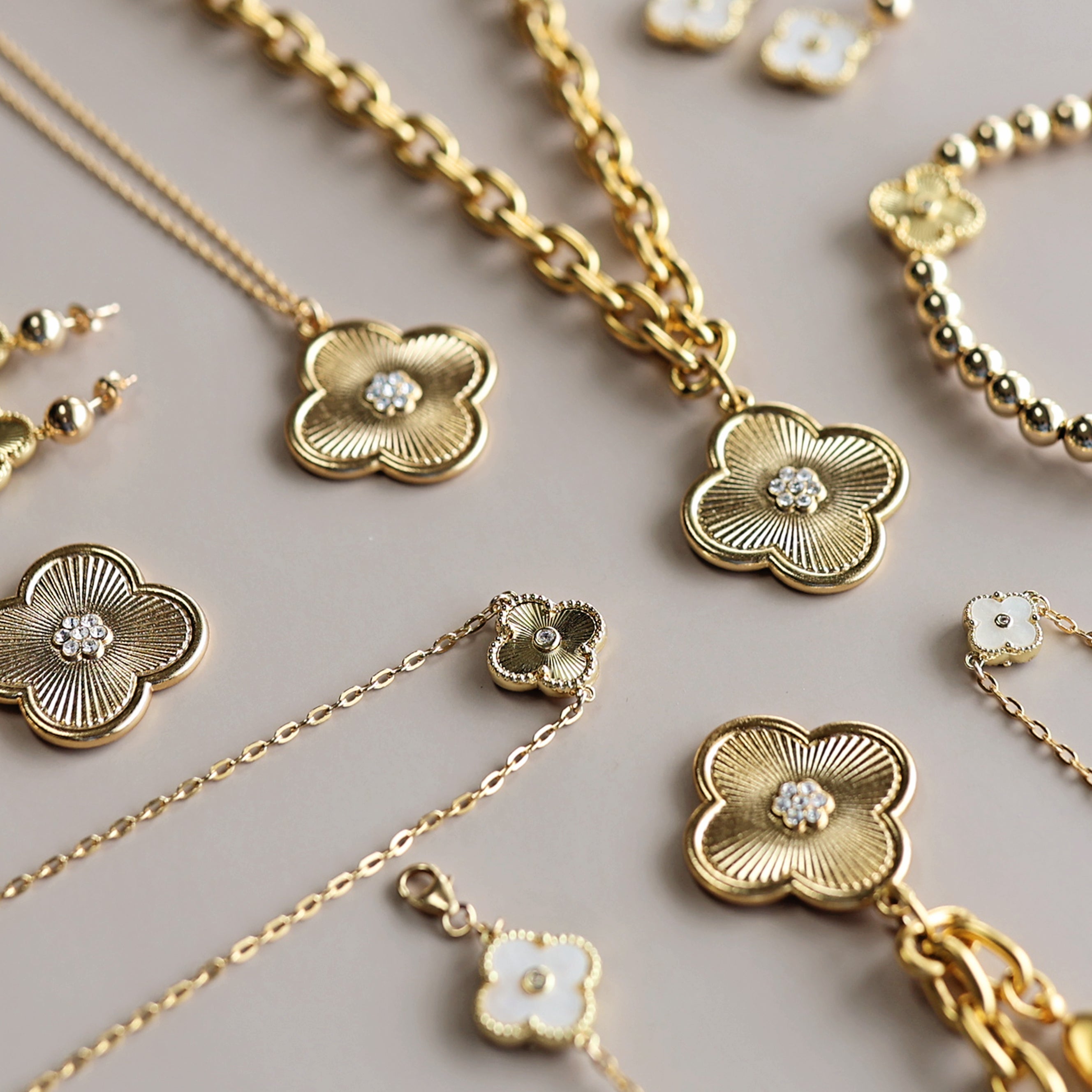 Gold jewelry set with clover designs