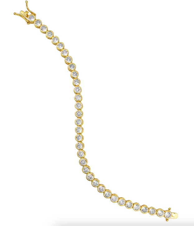 Gold bracelet with clear stones on a white background