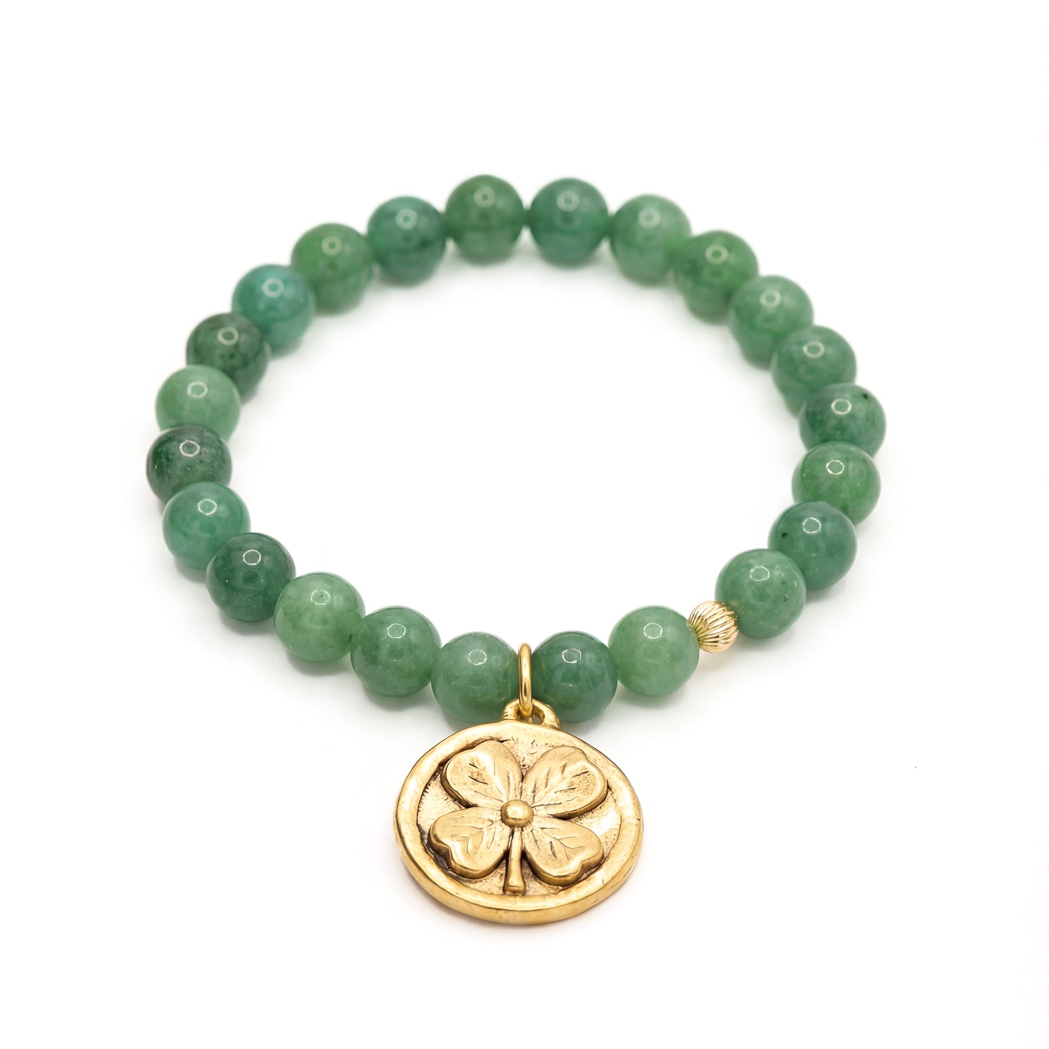 Green beaded bracelet with a gold four-leaf clover charm on a white background