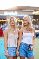 Rainbow-inspired summer statement necklace styled with casual resort wear.