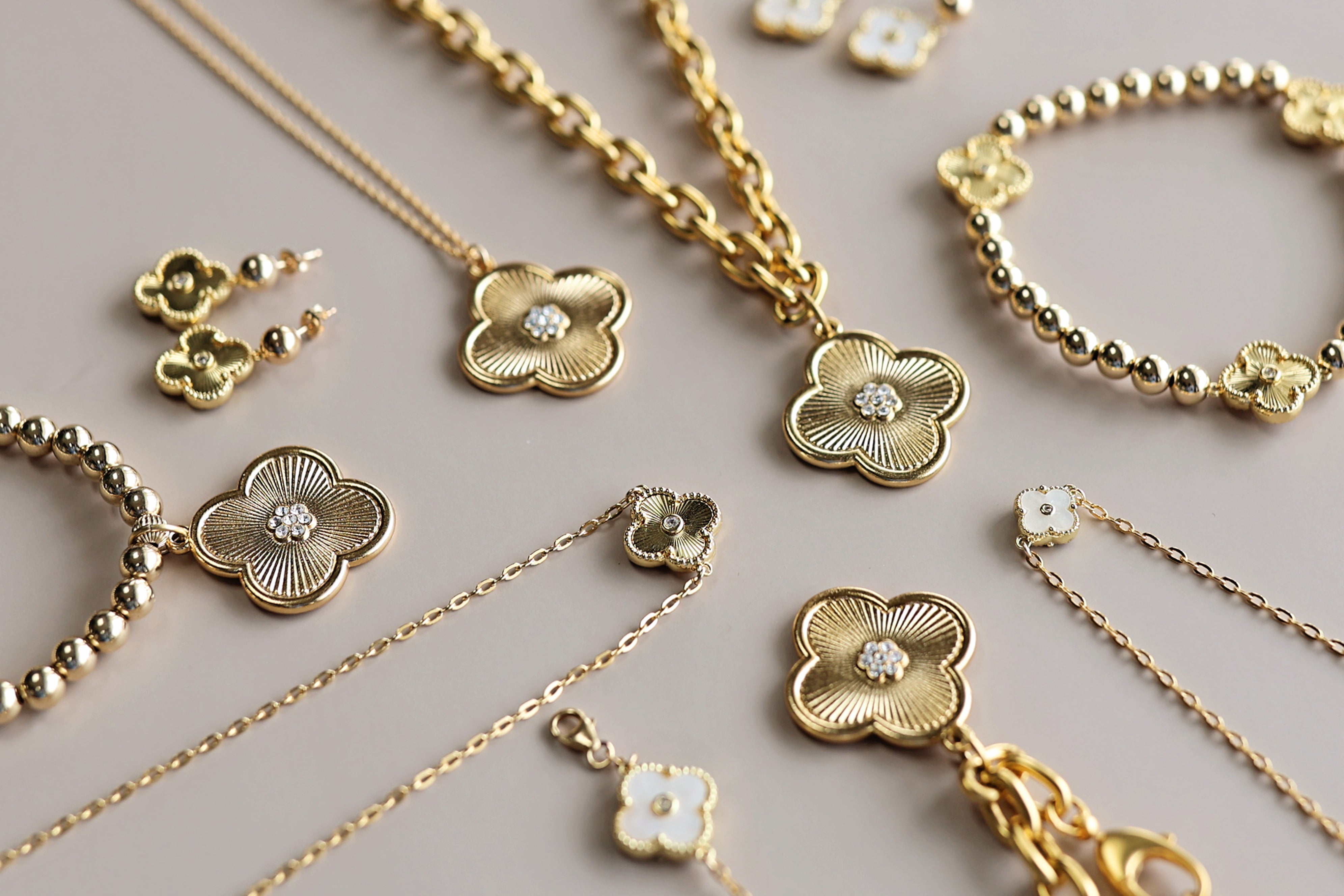 Gold jewelry set with clover designs