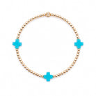 Bracelet with gold beads and turquoise cross charms on a white background