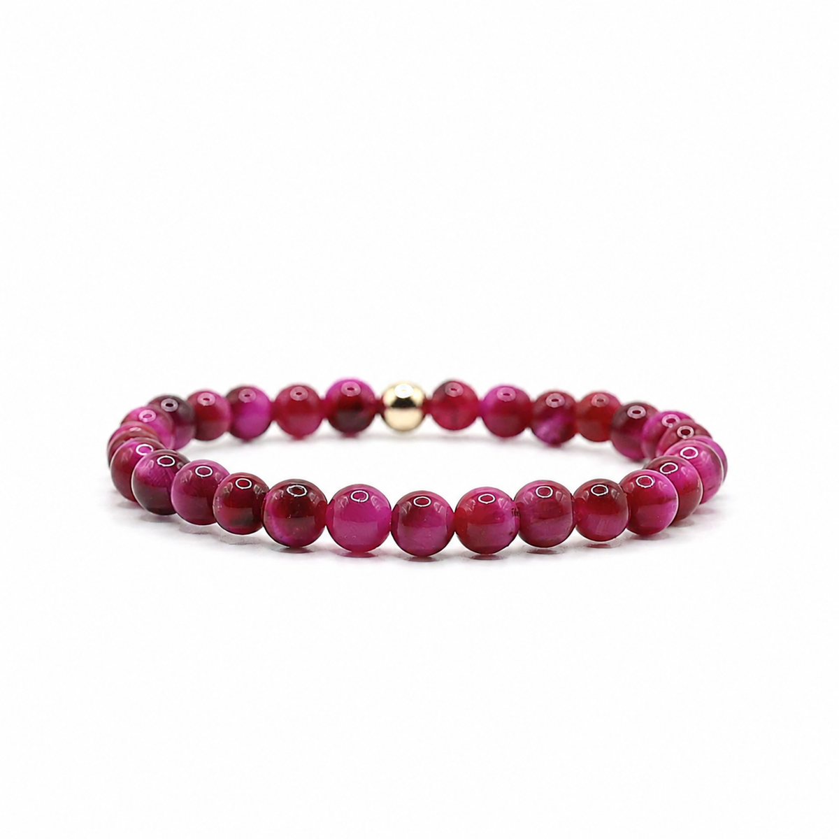 A beaded stretch bracelet featuring round magenta and deep red beads with a small polished gold spacer bead, displayed on a clean white background.