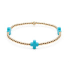 Bracelet with gold beads and turquoise cross charms on a white background