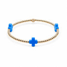 Gold bracelet with blue cross charms on a white background