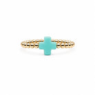 gold-filled beaded stretch ring with a turquoise cross charm.