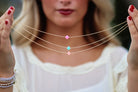 gold necklace with colorful cross
