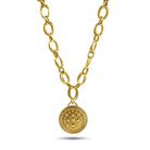 Gold chain necklace with a decorative pendant on a white background